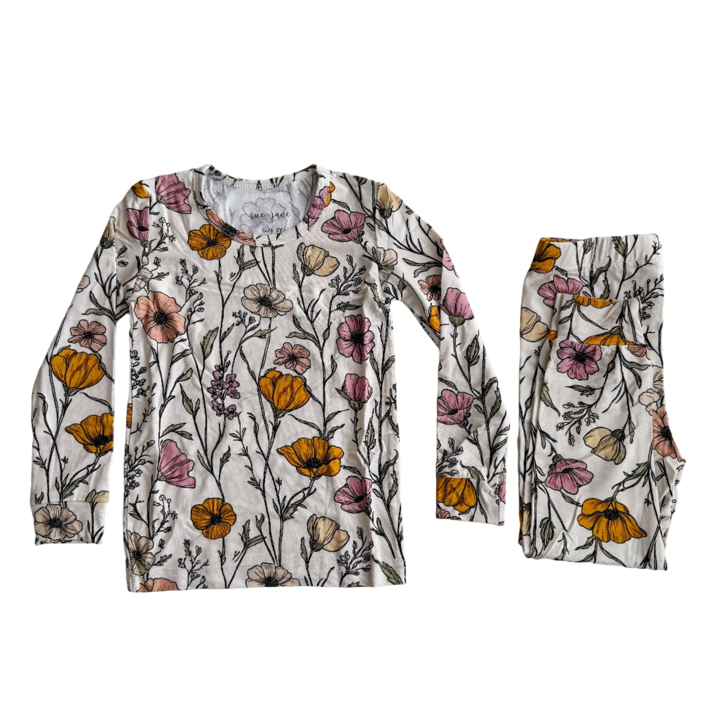 A set of kids' pajamas with long sleeves, featuring a floral pattern with poppy flowers in various colors on a white background.